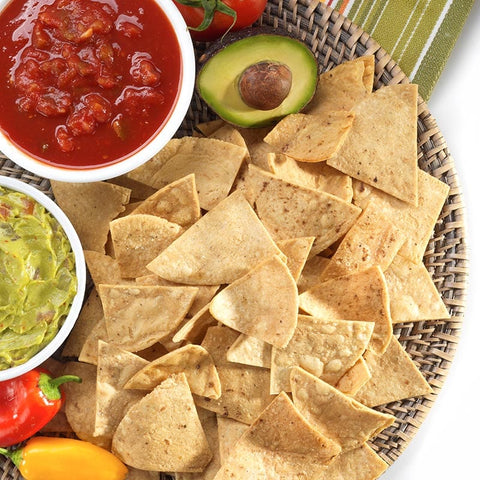 Tortilla chips, salsa, and guacamole - a delicious Mexican snack with crispy chips, tangy salsa, and creamy guacamole.